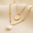 Pearl and Disc Layered Pendant Necklace in Gold on Beige Fabric