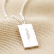 Close Up of Silver Personalised Birth Flower Tiny Tag Pendant Necklace With Clean Engraving