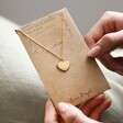 Model Holding Pink Enamel Heart Pendant Necklace in Gold in Packaging
