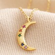 Rainbow Crystal Crescent Moon Pendant Necklace in Gold on Beige Fabric