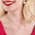 Close Up of Model Wearing Rainbow Crystal Crescent Moon Pendant Necklace in Gold