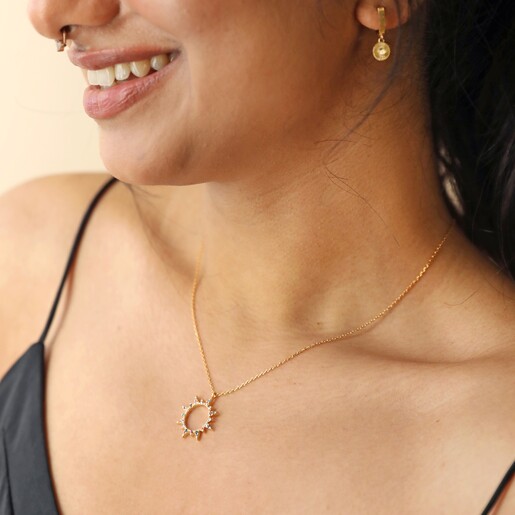 Model Wearing Rainbow Crystal Sunburst Pendant Necklace in Gold