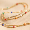 Rainbow Enamel Double Ball Chain Necklace in Gold Laid Out on Fabric