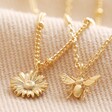 Set of 2 Daisy and Bee Necklaces in Gold on Folded Fabric