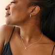 Model Wearing Tiny Pearl Initial Charm Necklace in Silver with Silver Earrings