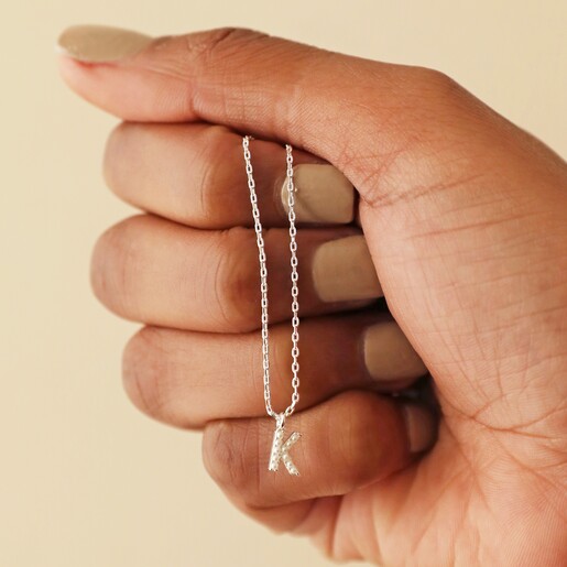 Model Holding Necklace Model Holding Tiny Pearl Initial Charm Necklace in Silver