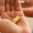 Model Holding Wildflower Envelope Locket Pendant Necklace in Gold