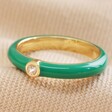Green Enamel Crystal Ring in Gold on Beige Fabric