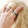 Model Wearing Green Enamel Crystal Ring in Gold with Hand in Hair