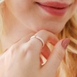Model Wearing Pink Enamel Crystal Ring in Gold with Hand on Chin
