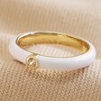 White Enamel Crystal Ring in Gold on Natural Coloured Fabric