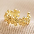 Tiny Daisy Chain Ear Cuff in Gold on Beige Fabric