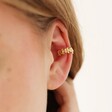 Close Up of Model Wearing Tiny Daisy Chain Ear Cuff in Gold