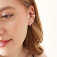 Model Wears Tiny Daisy Chain Ear Cuff in Silver With Other Silver Earrings