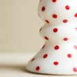 Close Up of Pattern on White and Red Spotty Candlestick Candle