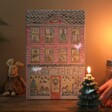 Fill Your Own Toy Shop Advent Calendar pn Dark Room Lit by Candlelight