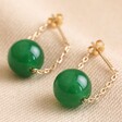 Green Agate Stone Bead Drop Earrings on Beige Fabric