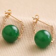 Pair of Green Agate Stone Bead Drop Earrings on Neutral Fabric