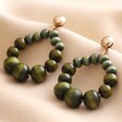Green Wooden Bead Drop Earrings on Beige Fabric