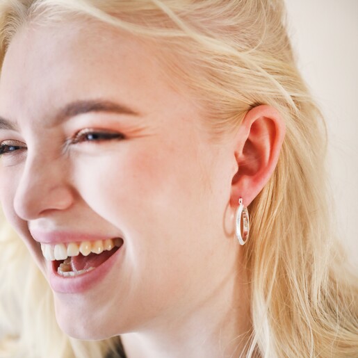 Herringbone Edge Hoop Earrings in Silver on Model Smiling