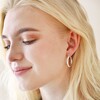 Herringbone Edge Hoop Earrings in Silver on Model Against Neutral Background