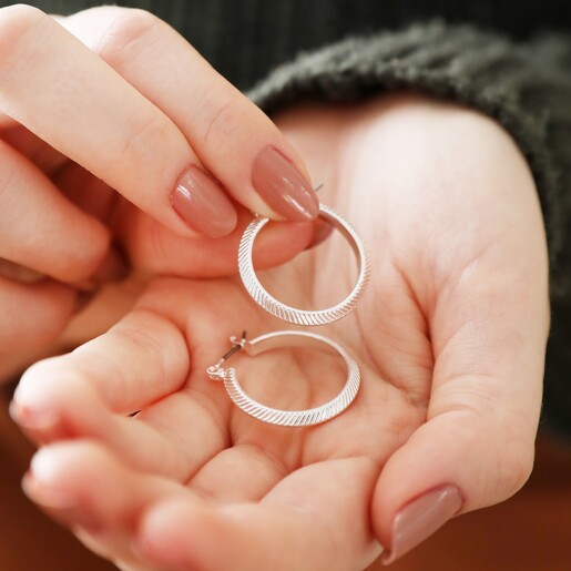 Herringbone Edge Hoop Earrings in Silver in Model's Hand