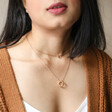 Model Wearing Layered Ring Pendant Necklace in Gold
