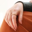Matte Hammered Organic Ring in Gold on Model Resting Hand on Knee