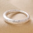 Matte Hammered Organic Ring in Silver on Beige Coloured Fabric