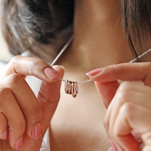 Model Holding Organic Hoops Pendant Necklace in Silver Showing Hoop Pendants