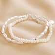 Pearl and Matte Bead Layered Bracelet in Silver on a Beige Background