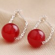 Red Agate Stone Bead Drop Earrings on Cream Fabric