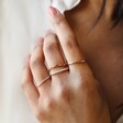 Model Wearing Set of 4 Silver and Rose Gold Stacking Rings Hand on Shirt