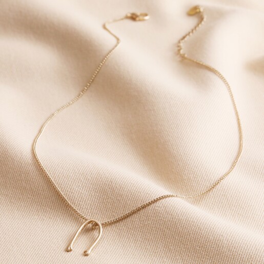 Slim Hug Hands Pendant Necklace in Gold on Natural Coloured Fabric