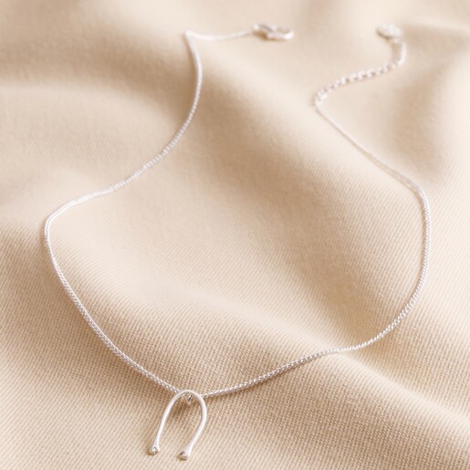 Slim Hug Hands Pendant Necklace in Silver on Neutral Coloured Fabric