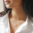 Close Up of Model Wearing Slim Hug Hands Pendant Necklace in Silver