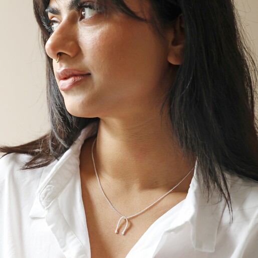 Slim Hug Hands Pendant Necklace in Silver on Brunette Model