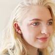 Model Wearing Textured Hoop Ear Cuff in Silver with Off-White Backdrop