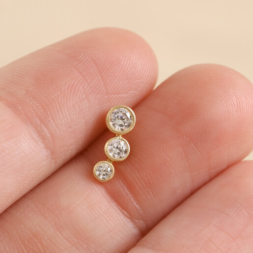 Model Holding Tish Lyon Solid Gold Crystal Bubble Barbell Between Fingers