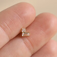 Model Holding Tish Lyon Solid Gold Crystal Chevron Barbell in Between Fingers