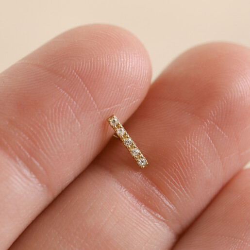 Model Holding Tish Lyon Solid Gold Crystal Microbar Barbell Between Fingers