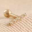 Tish Lyon Solid Gold Crystal Microbar Barbell on Beige Coloured Fabric