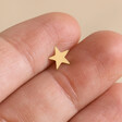Model Holding Tish Lyon Solid Gold Star Barbell Between Fingers