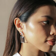 Model Wearing Big Metal London Cosette Gemstone Drop Earrings in Blue
