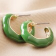 Big Metal London Green Enamel Irregular Hoop Earrings in Gold on Neutral Fabric