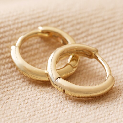 Close Up of Plain Huggies From Big Metal London Pack of 2 Bead Charm Huggie Hoop Earrings in Gold