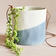 Burgon & Ball Dipped Indoor Hanging Planter in Blue Filled With House Plant