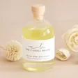 The Candle Brand Plum and Rhubarb Flower Diffuser on neutral backdrop with reeds in background