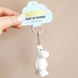 House of Disaster Moomin Keyring Held In Front of Neutral Wall