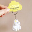 House of Disaster Moomin Love Keyring Held by Model Against Neutral Wall